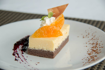  image of a piece cheese cake with mandarins.
