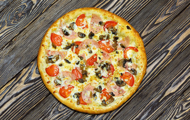 Italian pizza on wooden background, top view