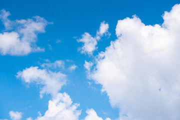 The blue sky with moving white clouds. The sky is a beautiful color shade suitable for use as a background image.