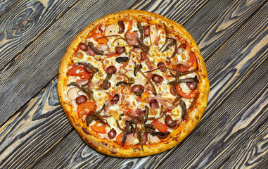 Italian pizza on wooden background, top view