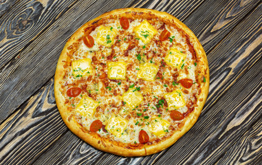 Italian pizza on wooden background, top view