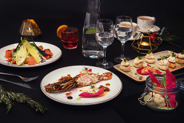 Tasty restaurant dishes: Cooked and stuffed crayfish, salad, appetizers, and crayfish ice-cream