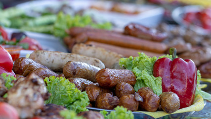 Grilled smoked sausages and meatballs outdoors. Meat baked on the grill bbq. Meat delicacies. Sausages homemade sausages on the grill.
