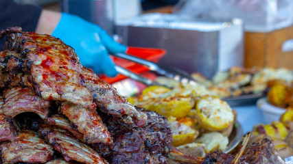 Grilled pork ribs on the grill. Pork ribs cooking on the grill, very tasty hot street food