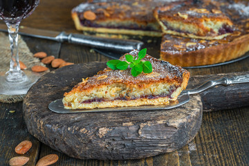 Traditional home baked bakewell tart on rustic wooden table