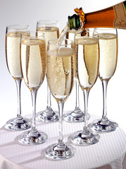 POURING SEVEN GLASSES OF CHAMPAGNE