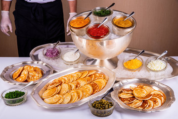 Giving of pancakes with fish snack