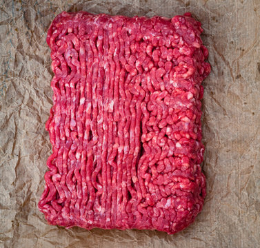 Block Of Minced Beef Meat On Wrinkled Brown Wax Paper