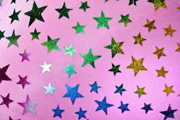 Bright shiny color stars on fabric gradient pink background