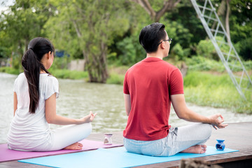 Young couple relaxing in yoga pose