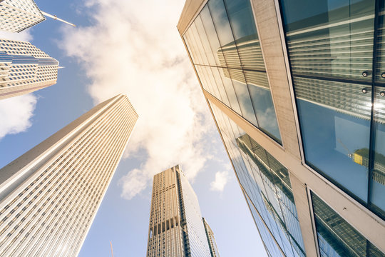 Vintage Tone Low Angle View Of Chicago Skylines And Reflection On Steel Metal Building Surface. Tall Buildings From Central Business District Downtown