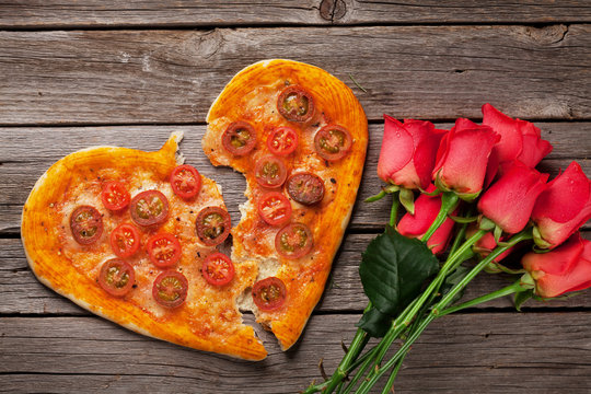 Heart shaped pizza with tomatoes and mozzarella