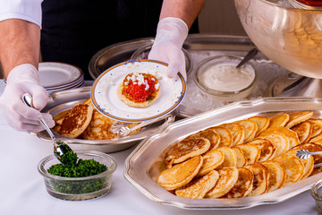 Pancake with poison, caviar, greens, falls down slot-hole onions for giving to the client