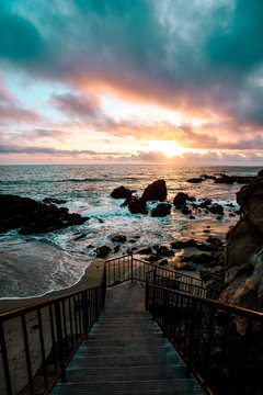 Stairs leading to the beach during sunset