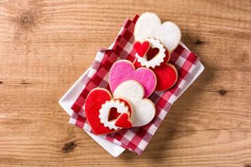 Heart-shaped cookies for Valentine's Day on wooden background. Top view. 