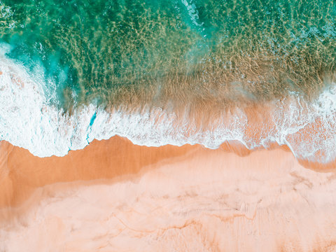 Aerial view of waves crashing along the shore