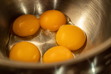 Some eggs in a stainless steel bowl
