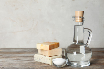 Composition with vinegar, baking soda and soap bars for cleaning on table. Space for text