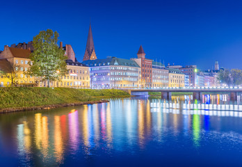 Night city view. Cityscape of Malmo at the evening, Sweden. Beautiful European town reflected in...