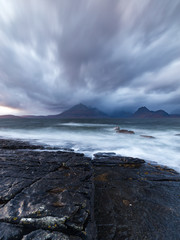 Storm clouds over the Cuilin Ridge and a rough sea at Elgol beach on the Isle of Skye, Scotland