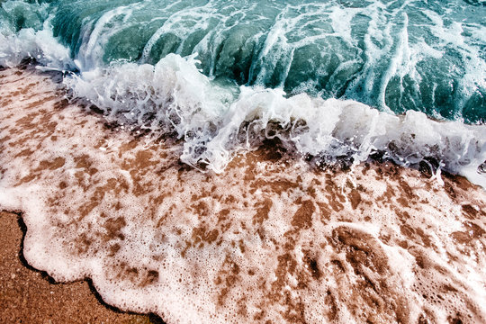 Waves crashing onto the sand