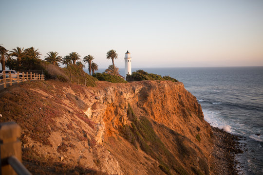 Lighthouse on top of a hill over looking a beach