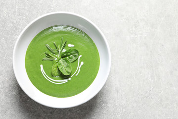 Fresh vegetable detox soup made of spinach in dish and space for text on table, top view