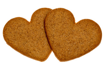Two gingerbread cookies in a heart shape