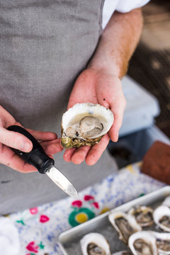 Man shucking fresh oysters