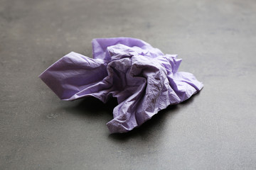 Crumpled paper napkin on grey background. Personal hygiene