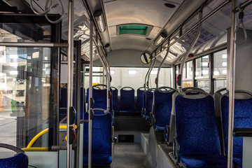 Interior of a modern city bus with blue seats