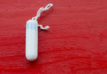 hygienic tampon on mahogany background 