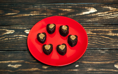 cupcakes with hearts in a plate on a wooden background