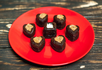 cupcakes with hearts in a plate on a wooden background