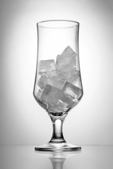 Transparent glass with ice, black and white photo, close-up
