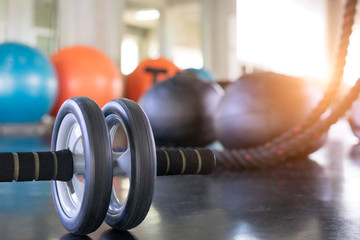Close up of a fitness equipment in gym. Exercise wheel in a gym. Fitness roller equipment. Selective focus.
