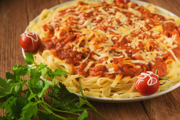 handmade pasta in tomato sauce with spices and vegetables in cheese breaded, decorated with parsley and cherry tomatoes