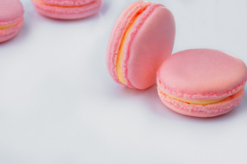 French macarons. Stack pink rose macaron on white background. Colorful macaroons