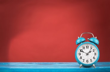 Retro alarm clock on table  background