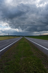 Fototapeta premium Highway before the storm. Dramatic clouds