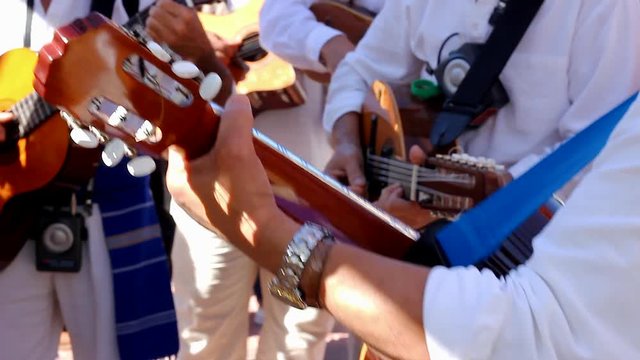 Local band on traditional clothes playing guitar on special event in Gran Canaria island, Spain. Musicians on party celebration in Canary Islands