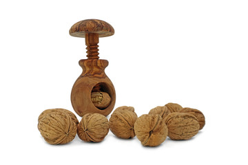 walnuts and wooden nutcracker isolated on white background