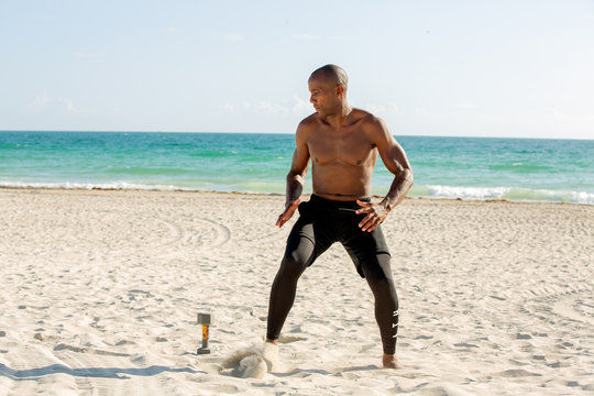 Man training hard on the beach