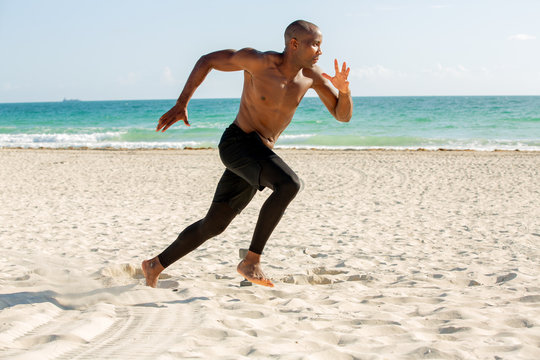 Young man running on the beach
