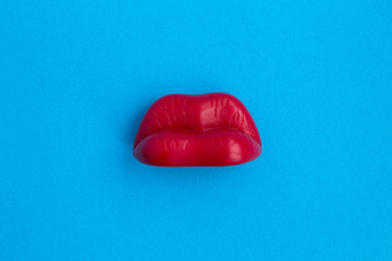Red lips on the blue background.Top view.Copy space.