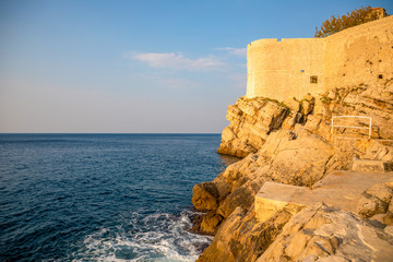 Dubrovnik, Croatia view of city walls overlooking walls and sea with cliffs during the day,...