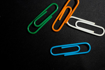 color paperclip on black background