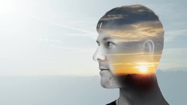 Portrait of young man with sunset, double exposure