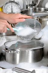 WOMAN WASHING POTS AND PANS