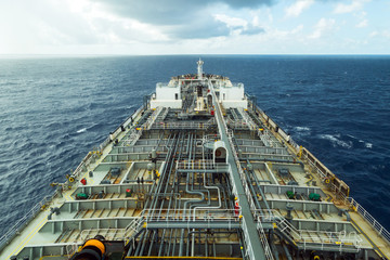 Oil product tanker deck while rainy weather. View from the navigation bridge.